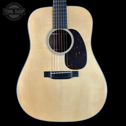 Acoustic guitar with a visible brand logo on a black background