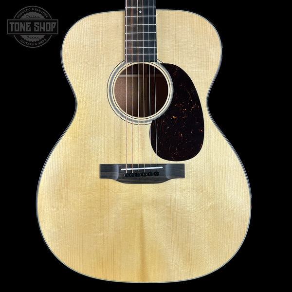 Acoustic guitar with a visible brand logo in the corner