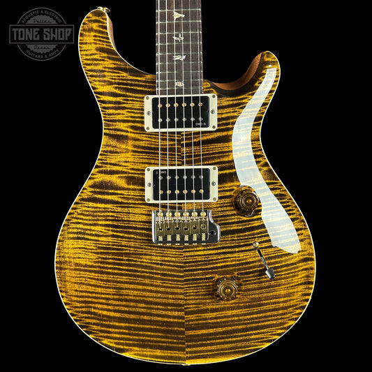 Electric guitar with a distinctive wood finish on a black background, featuring the 'Tone Shop' logo.