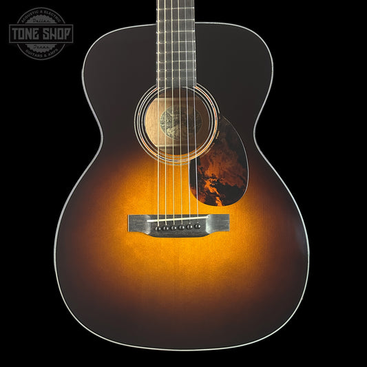 Acoustic guitar with a sunburst finish on a black background, featuring the Tone Shop logo.