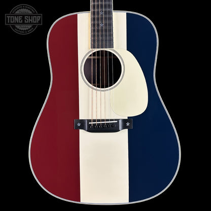 Acoustic guitar with red, white, and blue striped design on a black background