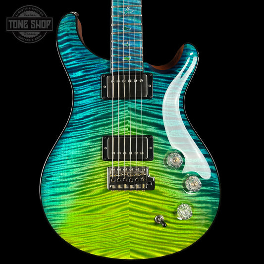 Electric guitar with a wavy green and blue design on a black background, featuring the 'Tone Shop' logo.