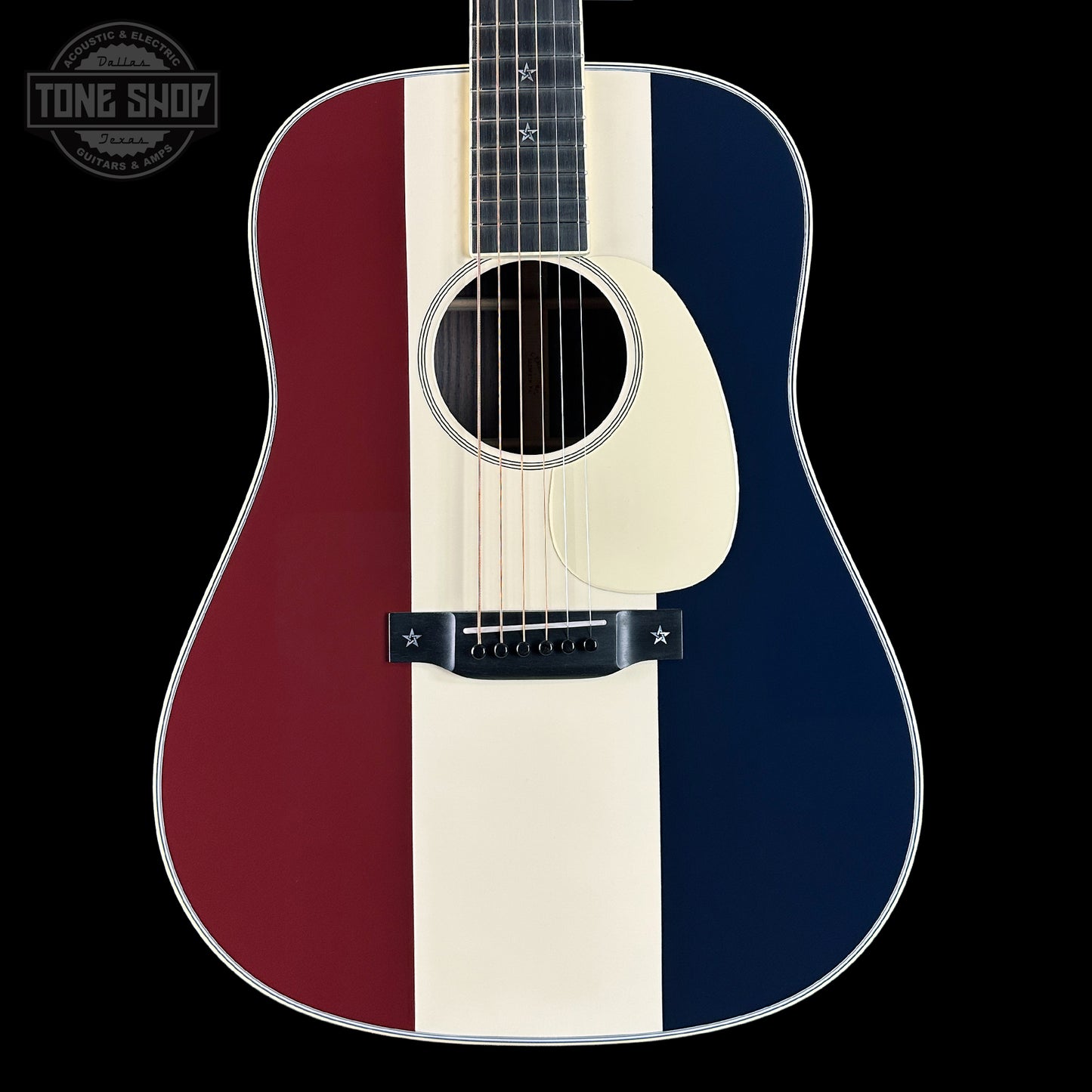 Acoustic guitar with a red, white, and blue striped design on a black background.