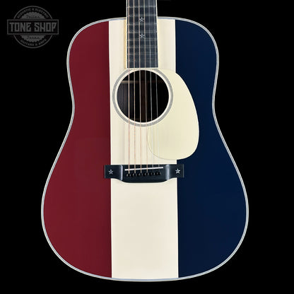 Acoustic guitar with a red, white, and blue striped design on a black background.