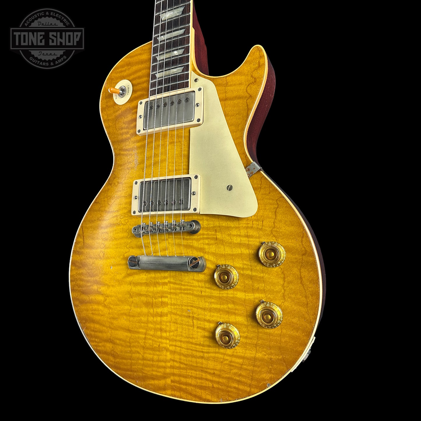 Electric guitar with a sunburst finish on a black background, featuring the Tone Shop logo.