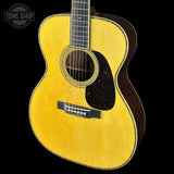 Acoustic guitar with a visible brand logo on a black background