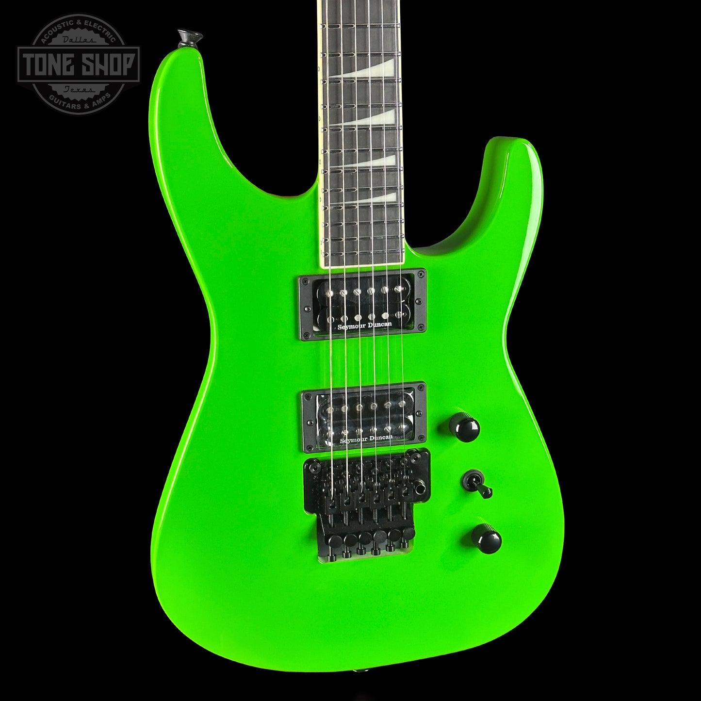 Green electric guitar with a black background