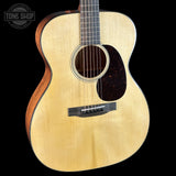 Acoustic guitar with a visible brand logo on a black background
