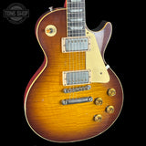 Electric guitar with a sunburst finish on a black background, featuring the Tone Shop logo.