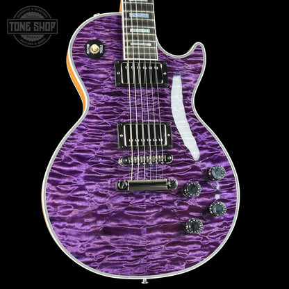 Purple electric guitar with a wavy pattern on a black background, featuring the Tone Shop logo.
