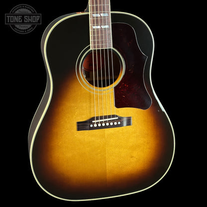 Acoustic guitar with a sunburst finish on a black background, featuring the Tone Shop logo.
