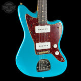 Blue electric guitar with a visible brand logo on a black background