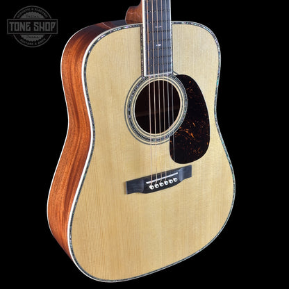 Acoustic guitar with a visible brand logo on a black background