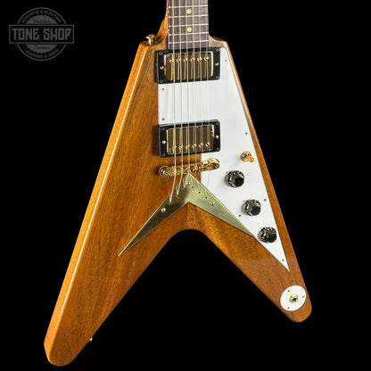 Wooden electric guitar with a white pickguard on a black background, featuring the Tone Shop logo.