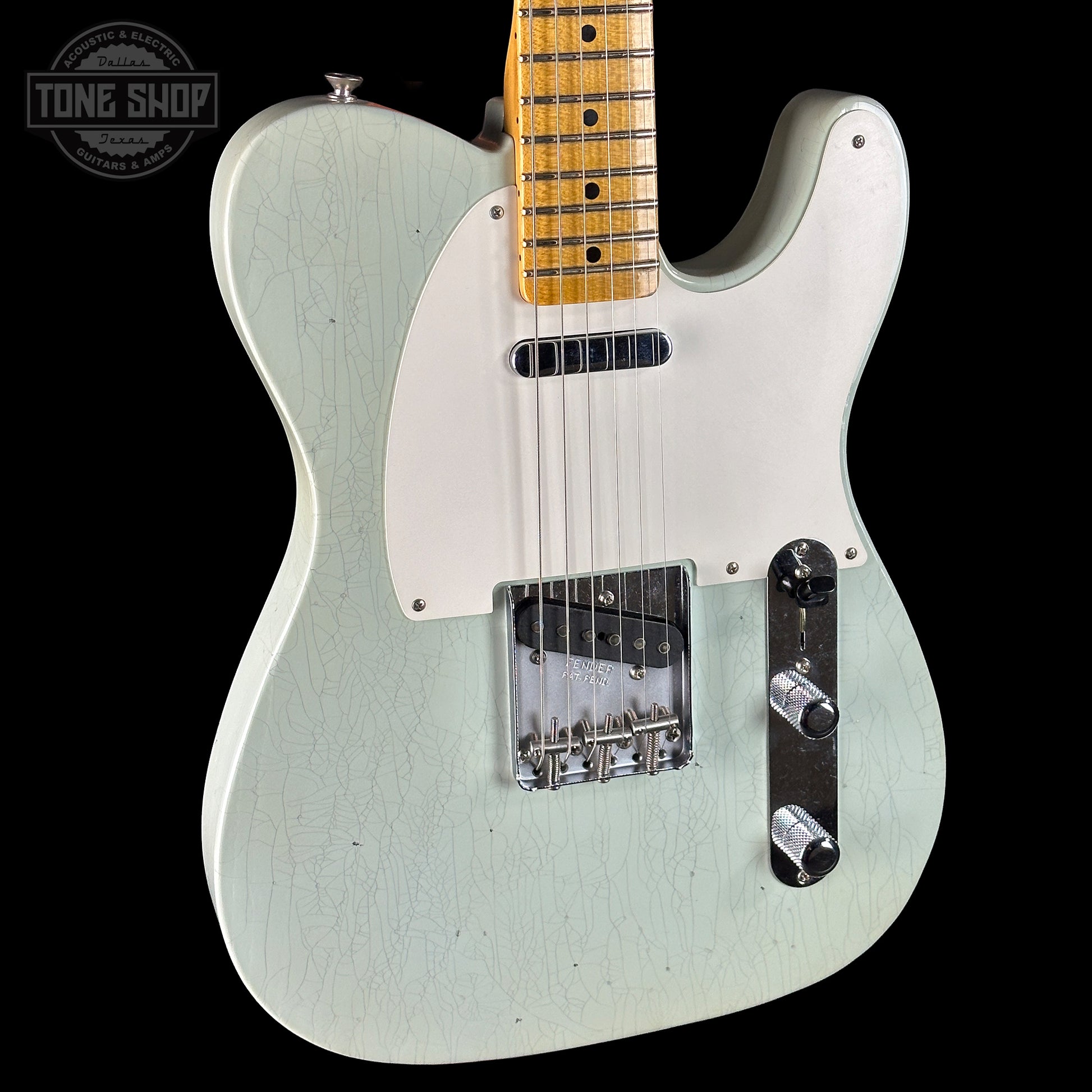 White electric guitar with a black background