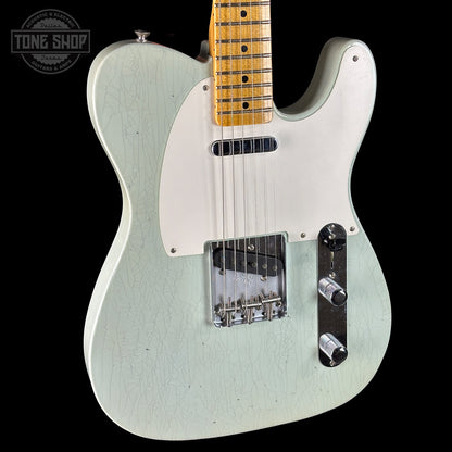 White electric guitar with a black background