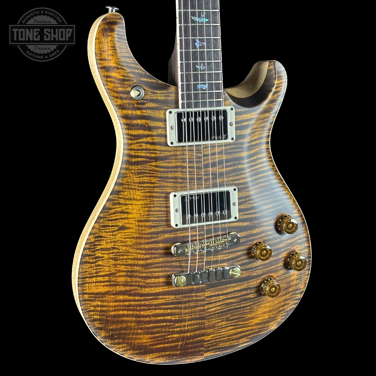 Wooden electric guitar with a visible brand logo in the corner