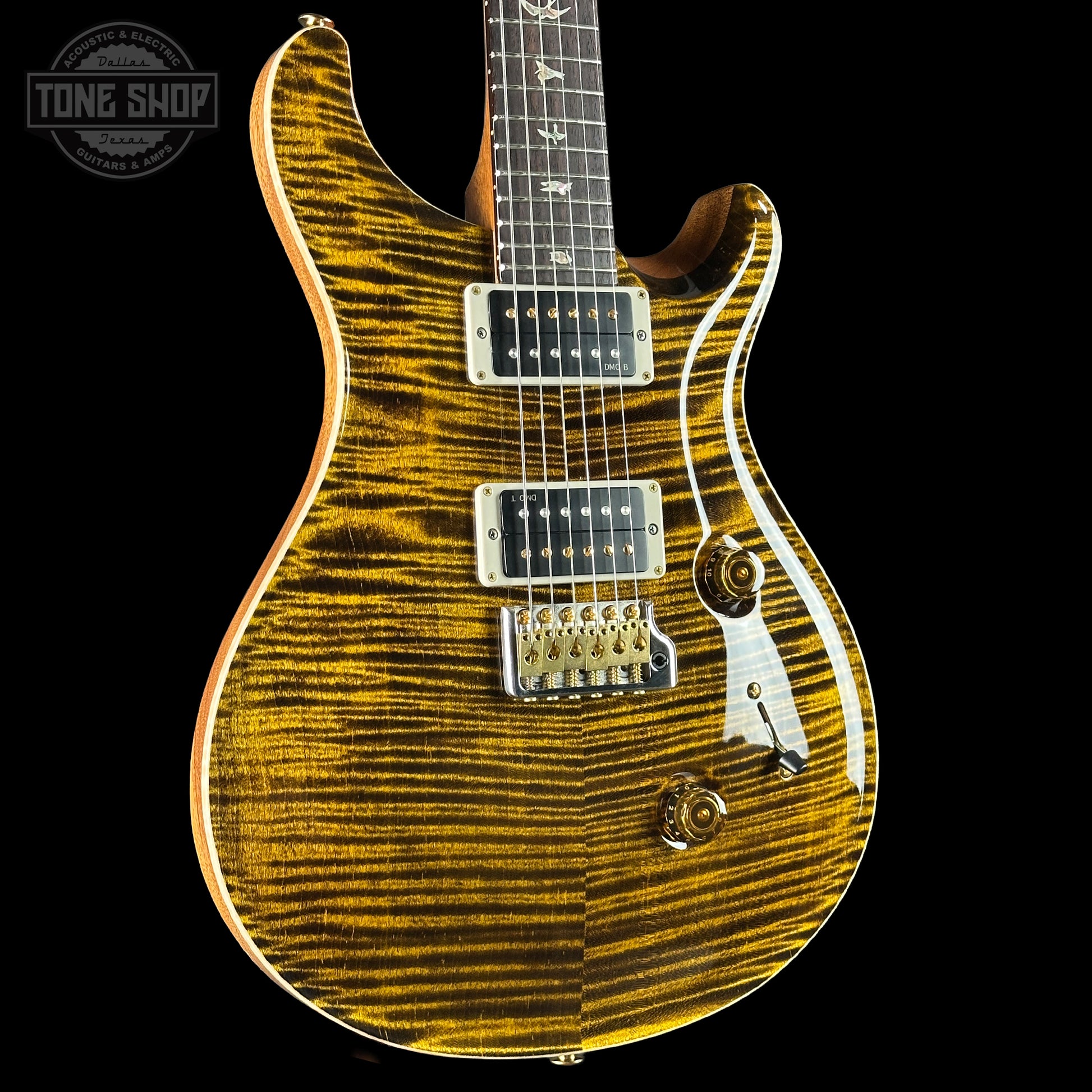 Electric guitar with a sunburst finish on a black background, featuring the Tone Shop logo.