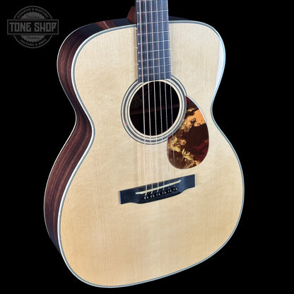 Acoustic guitar with a visible brand logo in the corner