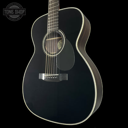 Black acoustic guitar on a black background with 'Tone Shop' logo.