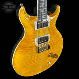 Yellow electric guitar with a 'Tone Shop' logo in the corner