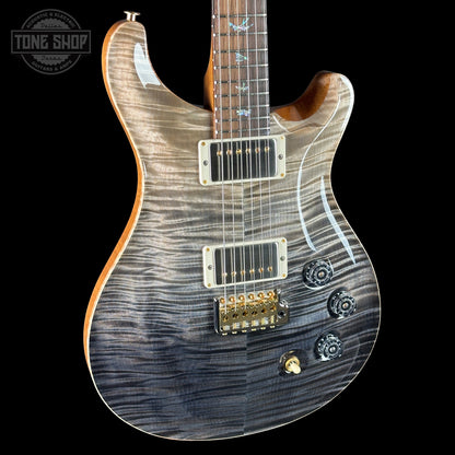 Electric guitar with a wavy wood finish on a black background, featuring the Tone Shop logo.