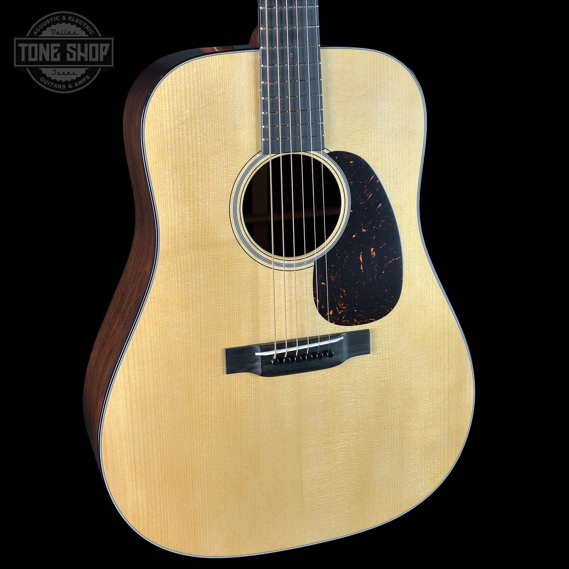 Acoustic guitar with a visible brand logo in the corner