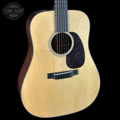 Acoustic guitar with a visible brand logo in the corner