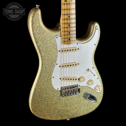 Gold glitter electric guitar on a black background with 'Tone Shop' logo.