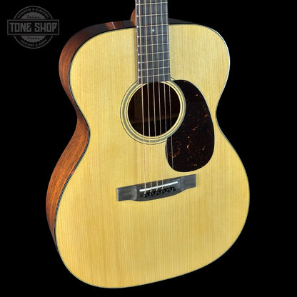 Acoustic guitar with a visible brand logo on a black background