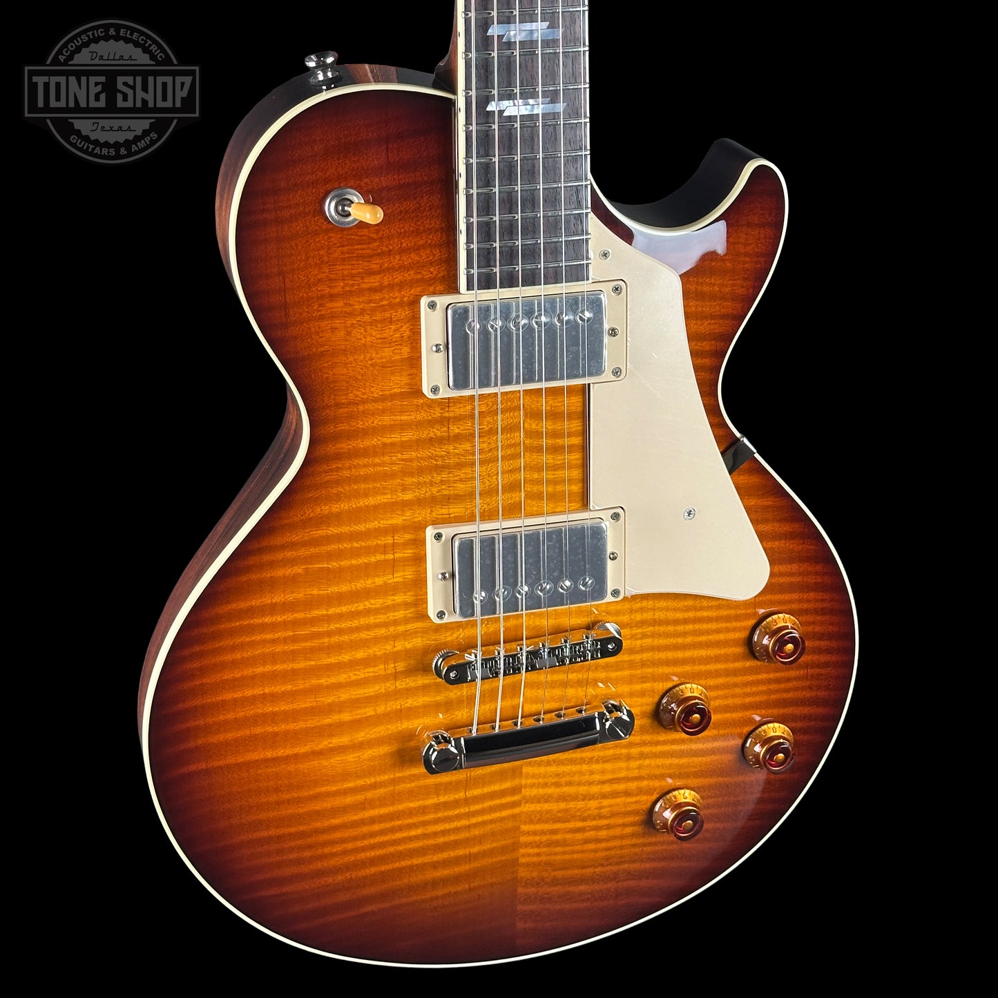 Electric guitar with a sunburst finish on a black background, featuring the Tone Shop logo.