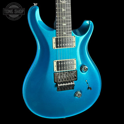 Blue electric guitar on a black background with 'Tone Shop' logo.