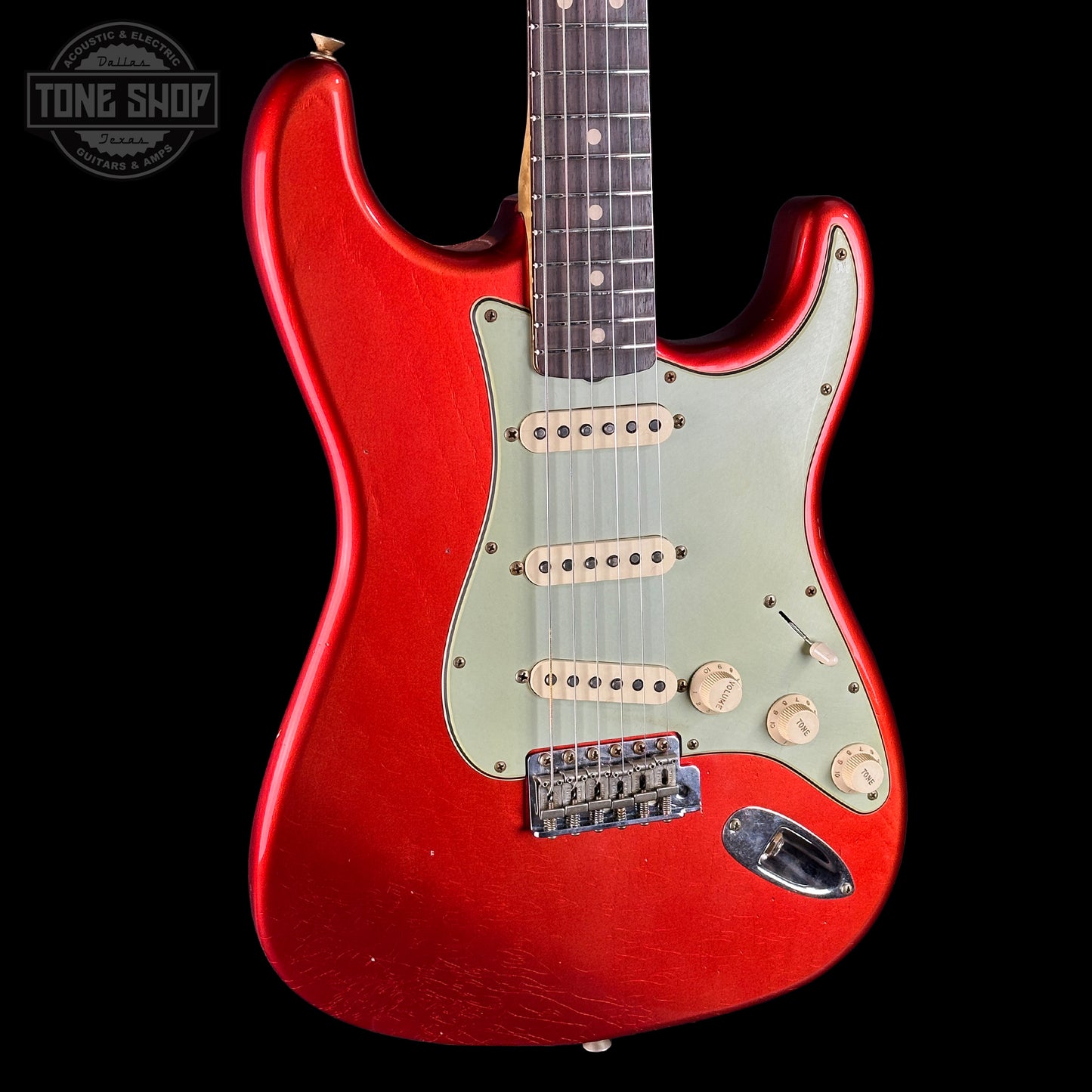 Front angle of Fender Custom Shop 1963 Stratocaster Journeyman Relic AAA Maple Neck Melon Candy.