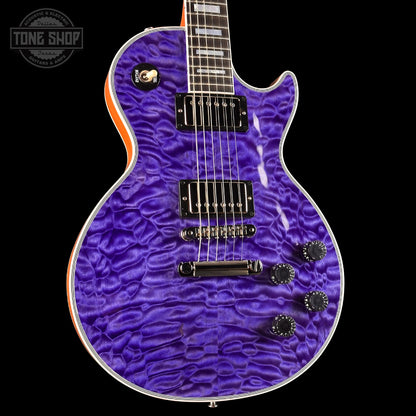 Purple electric guitar with a wavy finish on a black background, featuring the Tone Shop logo.