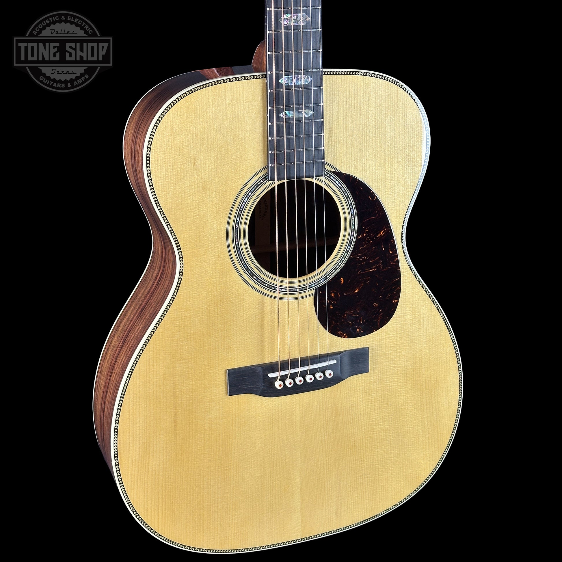 Acoustic guitar with a visible brand logo in the corner