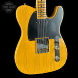 Electric guitar with a blonde finish on a black background, featuring the Tone Shop logo.