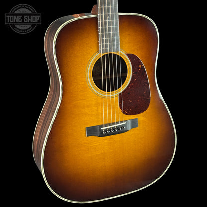 Acoustic guitar with a sunburst finish on a black background, featuring the Tone Shop logo.