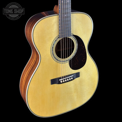 Acoustic guitar with a visible brand logo on a black background