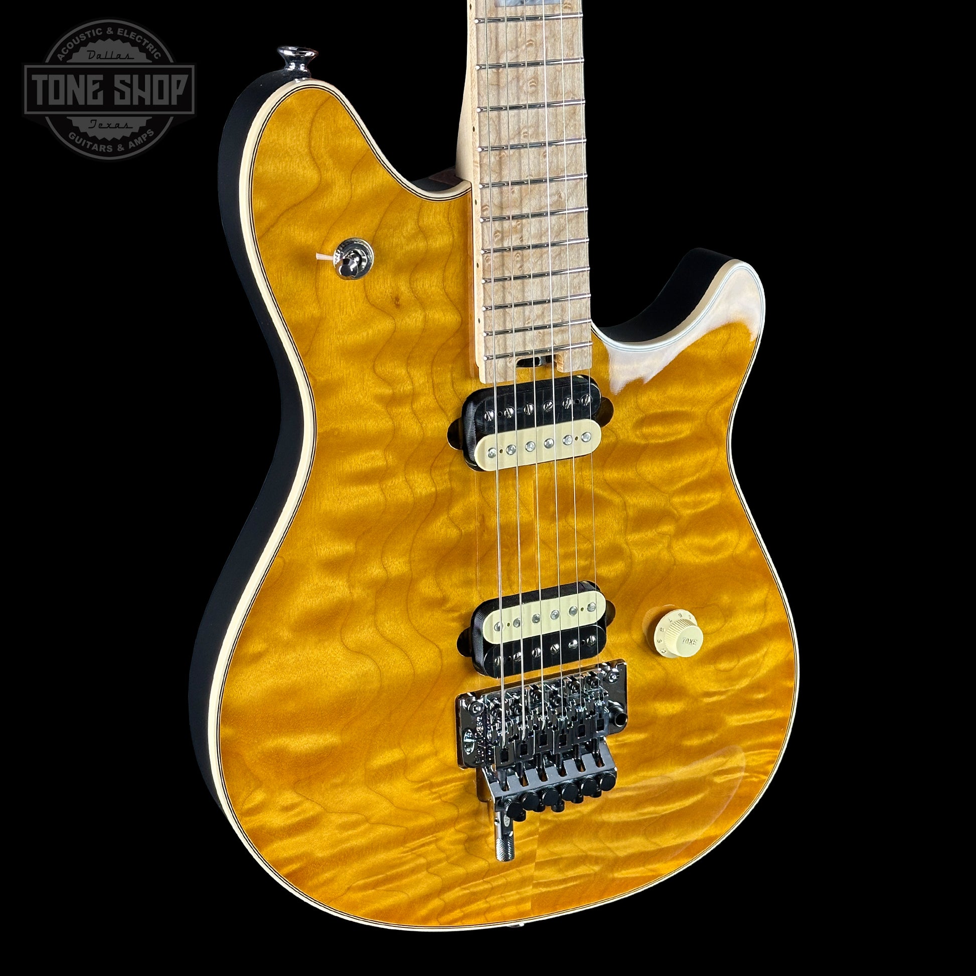 Electric guitar with a quilted top and visible brand logo on a black background