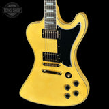 Yellow electric guitar on a black background with 'Tone Shop' logo.