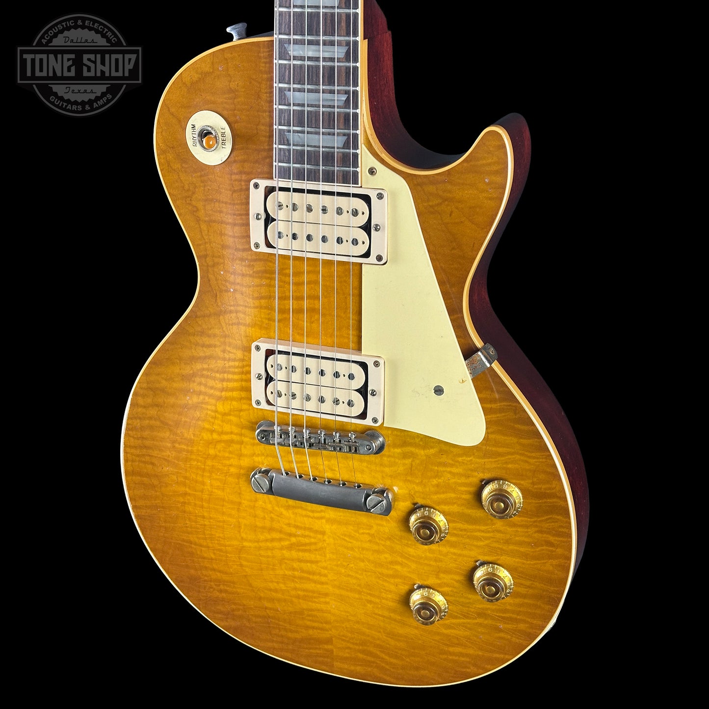 Gibson Les Paul electric guitar with a sunburst finish on a black background, featuring the Tone Shop logo.