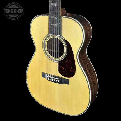 Acoustic guitar with a visible brand logo on a black background