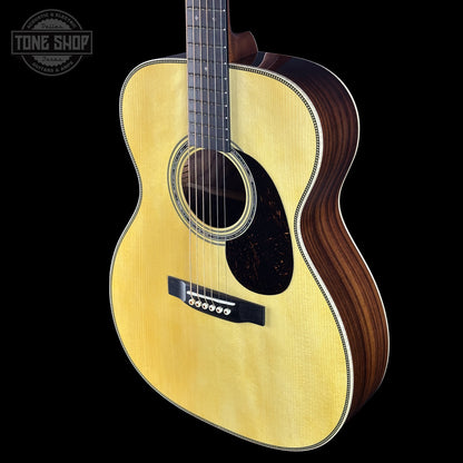 Acoustic guitar with a visible brand logo on a black background