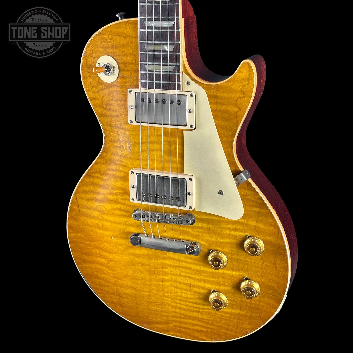 Electric guitar with a sunburst finish on a black background, featuring the Tone Shop logo.