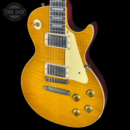 Electric guitar with a sunburst finish on a black background, featuring the Tone Shop logo.