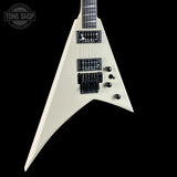 White electric guitar with a distinctive shape on a black background, featuring the Tone Shop logo.