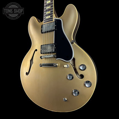 Gold electric guitar on a black background with 'Tone Shop' logo.