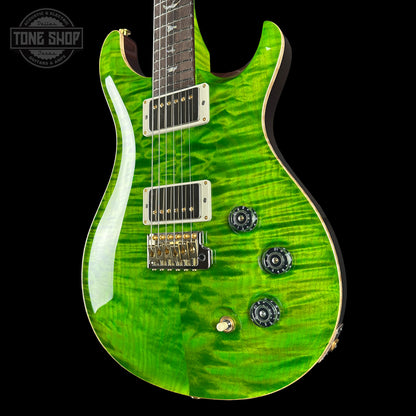 Green electric guitar with a black background