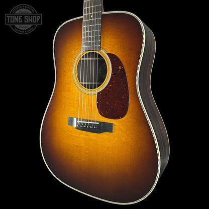 Acoustic guitar with a sunburst finish on a black background, featuring the Tone Shop logo.