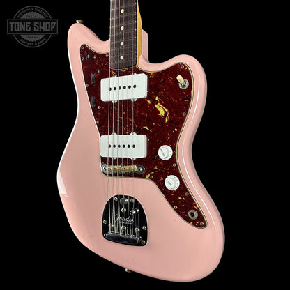 Pink electric guitar on a black background